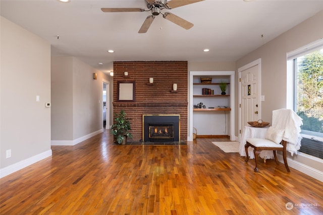 2804 M Ave, Anacortes, WA 98221 - living room featuring a brick fireplace, hardwood / wood-style floors, ceiling fan, and built in shelves