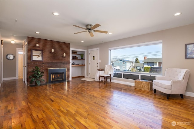 2804 M Ave, Anacortes, WA 98221 - living area with ceiling fan, wood-type flooring, and a brick fireplace