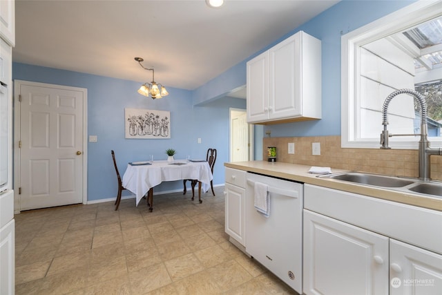 2804 M Ave, Anacortes, WA 98221 - kitchen with sink, hanging light fixtures, white dishwasher, white cabinets, and a chandelier