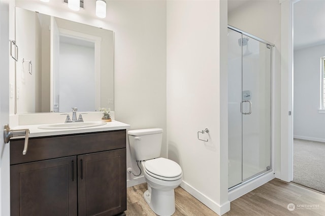 bathroom featuring vanity, a shower with shower door, and hardwood / wood-style floors