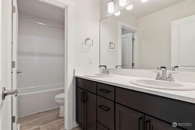 bathroom with vanity, hardwood / wood-style floors, and toilet