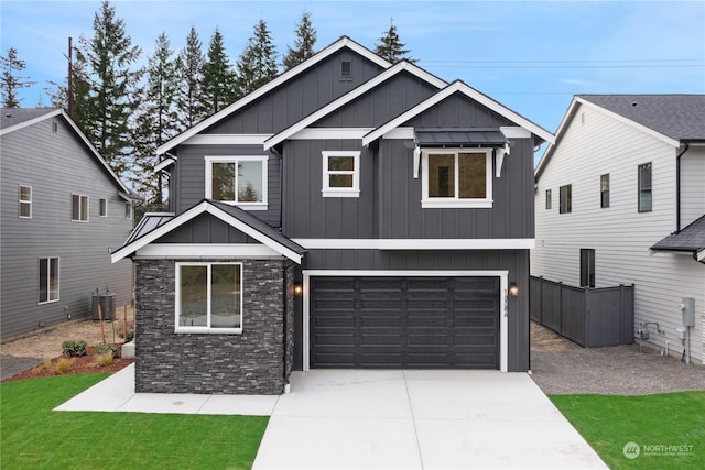 craftsman-style home featuring a garage, central AC, and a front lawn