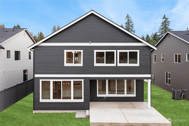 rear view of property with central AC, a patio area, and a lawn