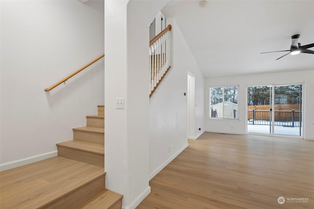 stairway with ceiling fan and hardwood / wood-style floors