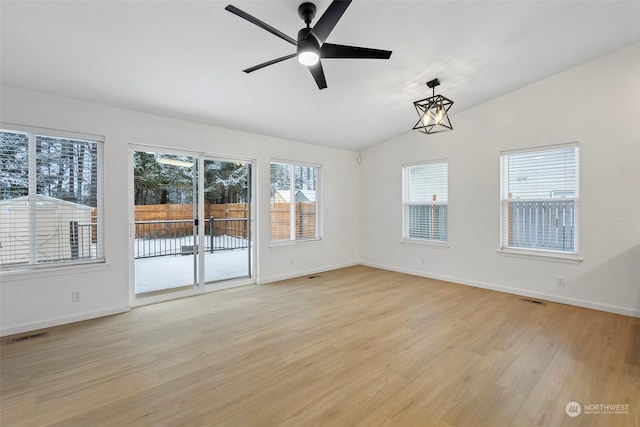 unfurnished room featuring ceiling fan, vaulted ceiling, and light wood-type flooring