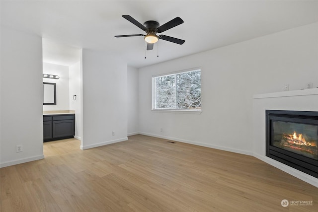 unfurnished living room with light hardwood / wood-style floors and ceiling fan