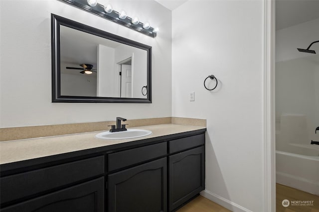 bathroom featuring vanity, shower / washtub combination, and ceiling fan