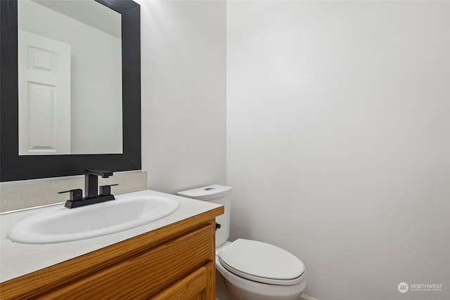 bathroom featuring vanity and toilet