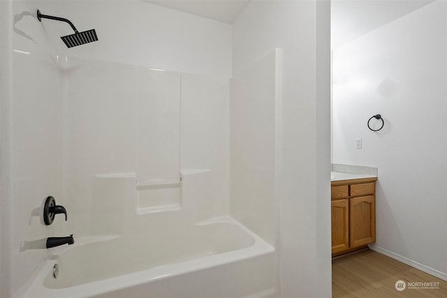 bathroom with hardwood / wood-style flooring, vanity, and bathtub / shower combination