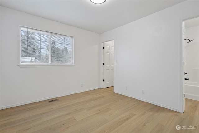 unfurnished room featuring light hardwood / wood-style flooring