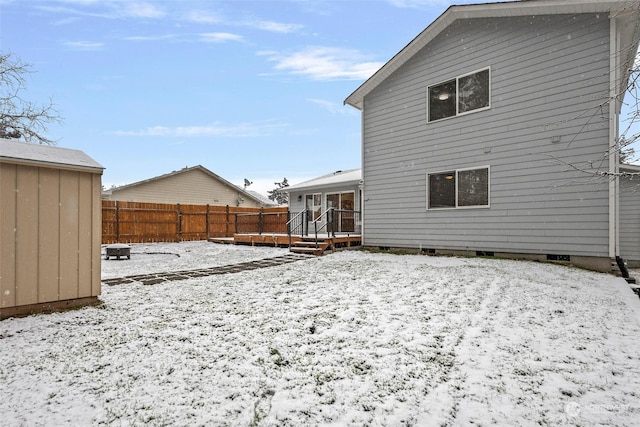 snow covered property with a wooden deck