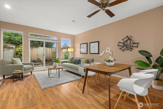 living room featuring light wood-style flooring and a ceiling fan