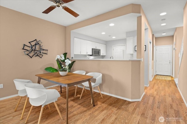 dining room featuring recessed lighting, baseboards, ceiling fan, and light wood finished floors