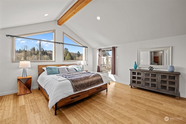 bedroom with vaulted ceiling with beams and light wood-type flooring