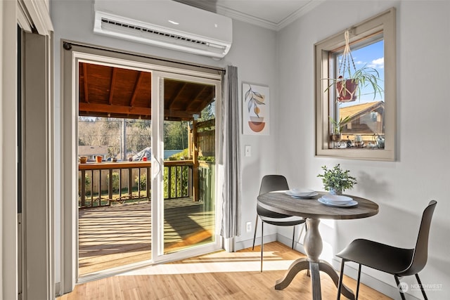 doorway to outside featuring ornamental molding, a wall unit AC, and light hardwood / wood-style floors