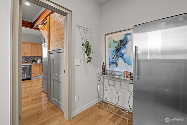 corridor with light hardwood / wood-style flooring