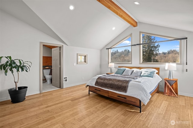 bedroom featuring connected bathroom, vaulted ceiling with beams, and light hardwood / wood-style flooring