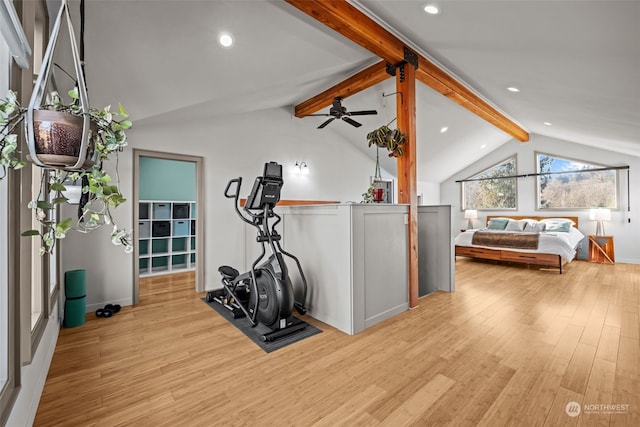 workout room featuring vaulted ceiling and light hardwood / wood-style floors