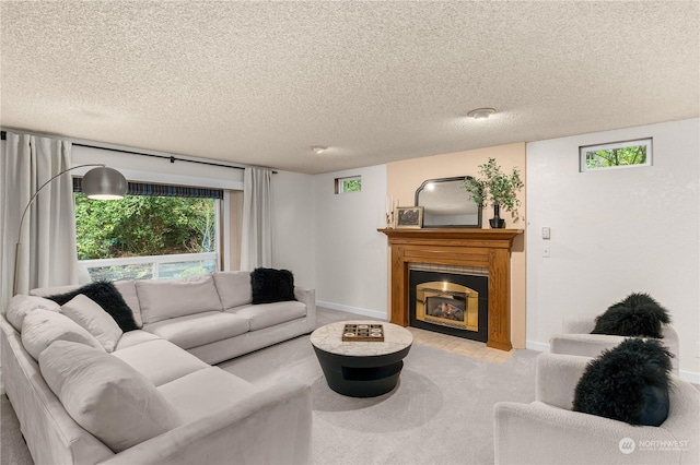 carpeted living room with plenty of natural light and a textured ceiling