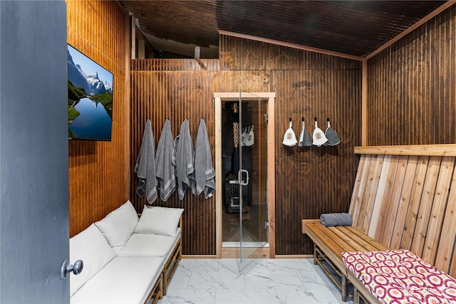 mudroom featuring lofted ceiling, wooden walls, and wooden ceiling