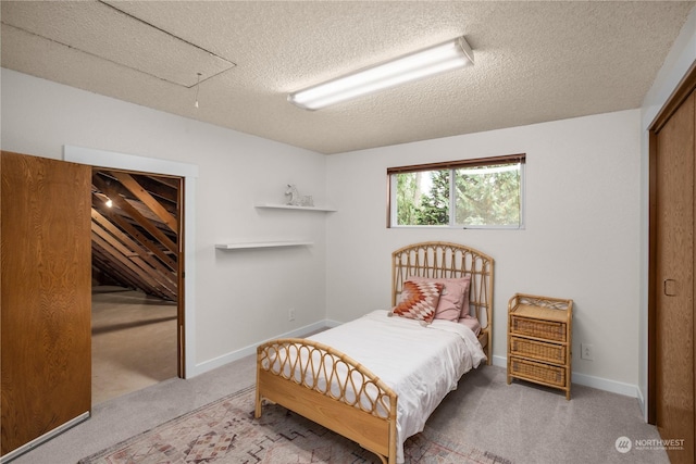 bedroom with carpet floors, a textured ceiling, and a closet