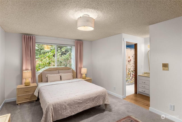 carpeted bedroom featuring a textured ceiling