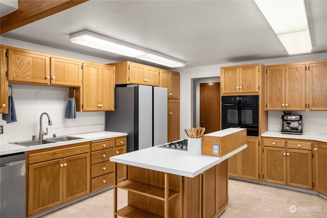 kitchen with a center island, appliances with stainless steel finishes, and sink