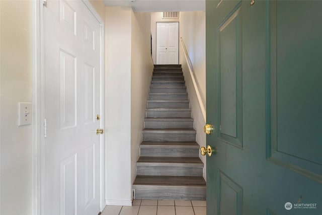 staircase with tile patterned flooring