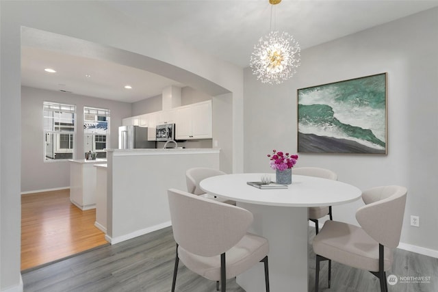 dining area featuring a notable chandelier and hardwood / wood-style flooring