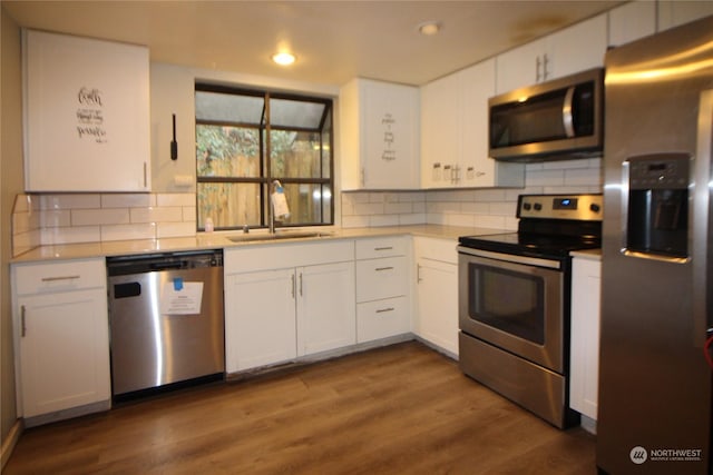 kitchen with white cabinetry, appliances with stainless steel finishes, sink, and tasteful backsplash