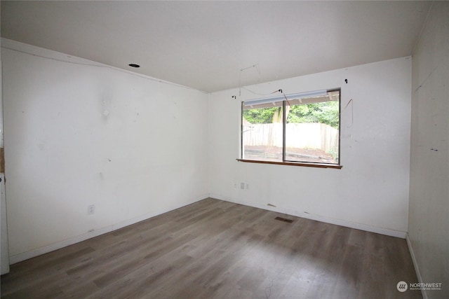 spare room with hardwood / wood-style flooring