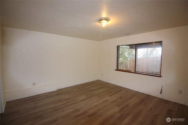 unfurnished room featuring dark hardwood / wood-style flooring