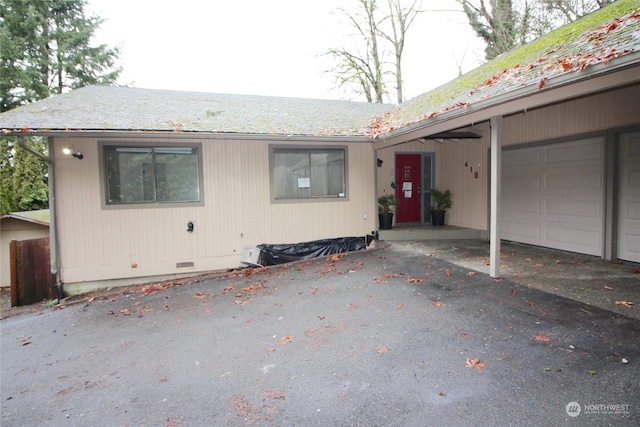 view of front of home featuring a garage and a carport