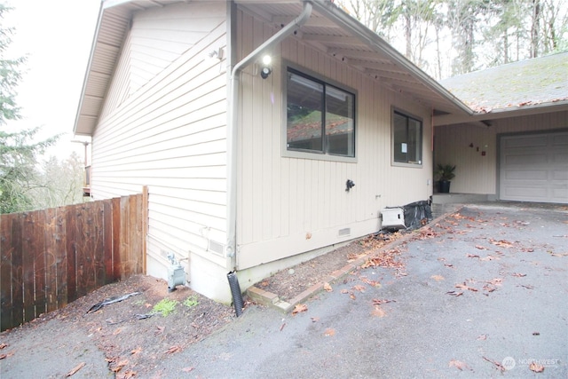 view of side of property featuring a garage