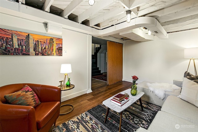 living room with dark wood-type flooring and beamed ceiling