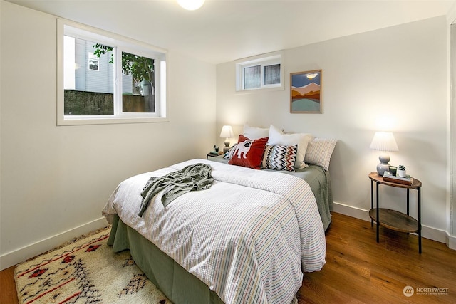 bedroom with dark hardwood / wood-style flooring