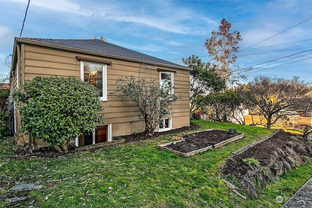 view of property exterior featuring a lawn