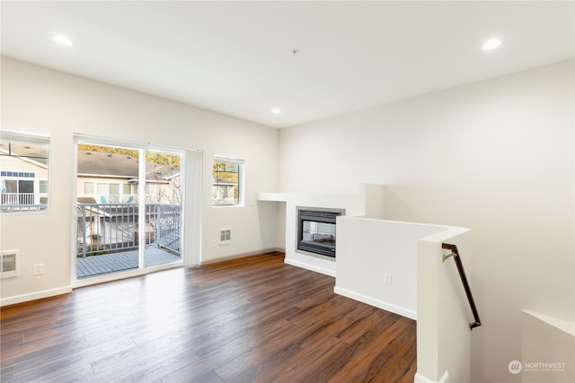 unfurnished living room featuring dark hardwood / wood-style flooring