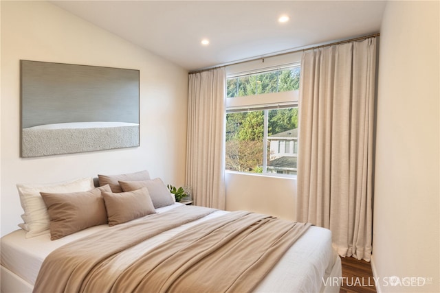 bedroom with hardwood / wood-style flooring and vaulted ceiling