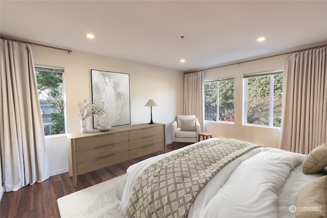 bedroom with dark hardwood / wood-style floors