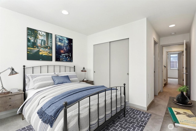 4407 42nd Ave SW Unit D, Seattle, WA 98116 - bedroom featuring baseboards, light carpet, a closet, and recessed lighting