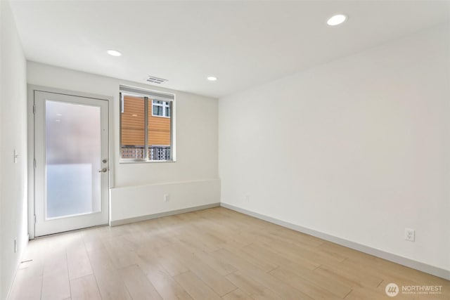 4407 42nd Ave SW Unit D, Seattle, WA 98116 - unfurnished room featuring light wood-style floors, recessed lighting, and visible vents