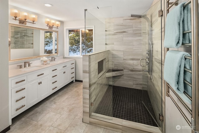 full bathroom featuring a stall shower, a sink, recessed lighting, and double vanity