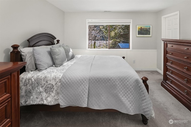 bedroom featuring carpet floors, visible vents, and baseboards