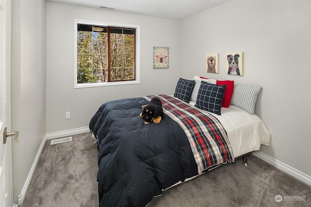 carpeted bedroom with visible vents and baseboards