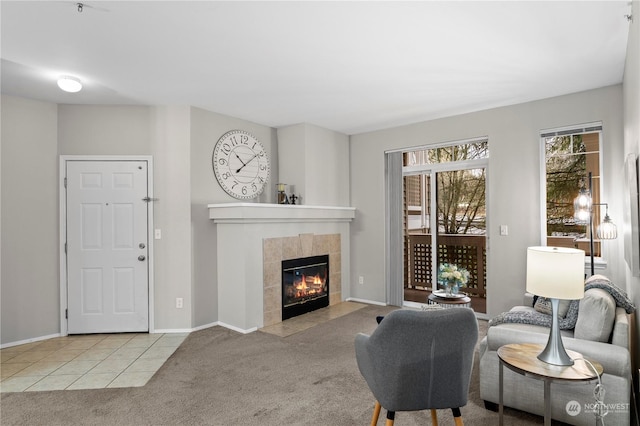 carpeted living room with a tiled fireplace