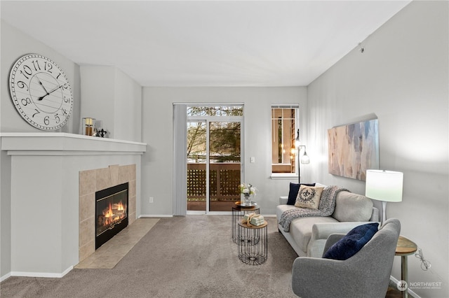 living room with light carpet and a tiled fireplace