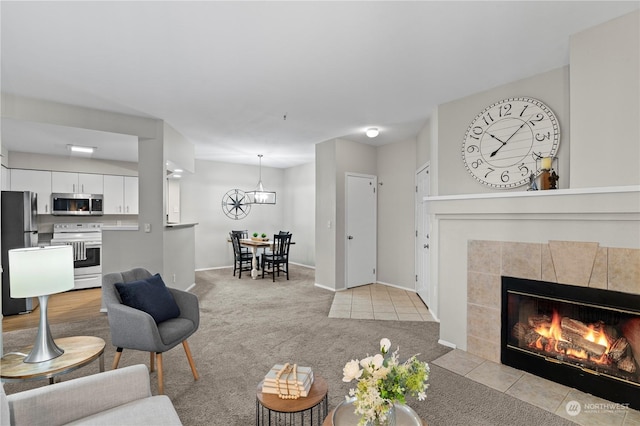 carpeted living room featuring a tile fireplace