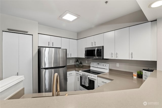 kitchen featuring white cabinetry and appliances with stainless steel finishes