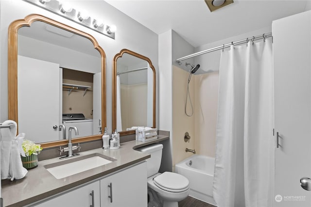 full bathroom featuring vanity, washer / dryer, shower / bath combo with shower curtain, and toilet